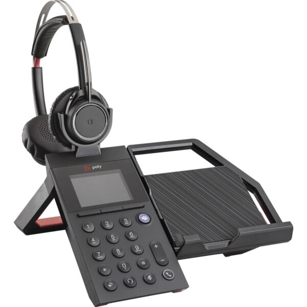 A phone and headset sitting on top of a desk.