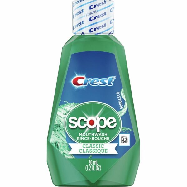 A bottle of mouthwash with the word " crest " written on it.